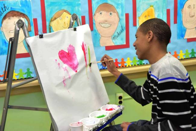 Felician School Art Show participant painting during the event