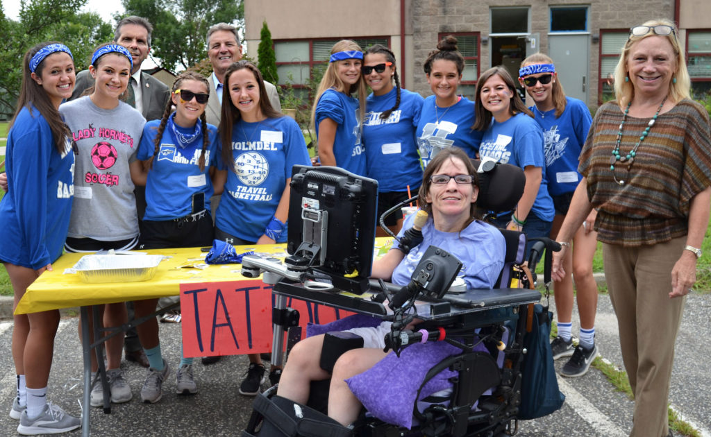 Monmouth County Freeholders Pat Impreveduto and Gerry Scharfenberger (back row, left) join Holmdel High School athletes, LADACIN Executive Director, Patricia Carlesimo, and Denise, a former client and employee at LADACIN Network’s Schroth School carnival.